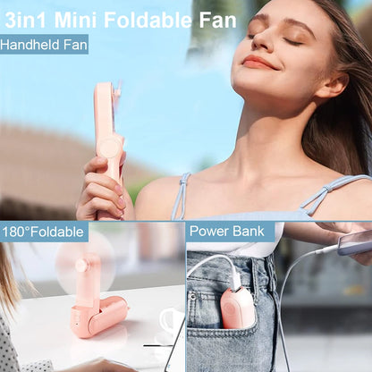 Pink mini handheld folding fan held in hand with tri-blade airflow head