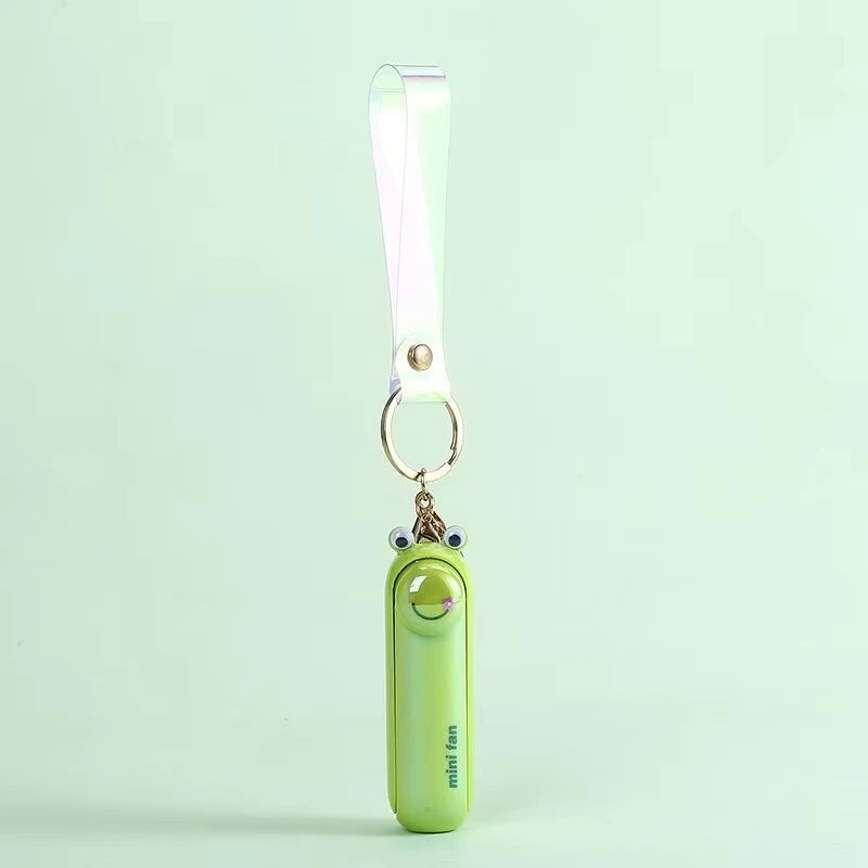 Green mini handheld keychain fan with ribbon strap and metal key ring, front view.