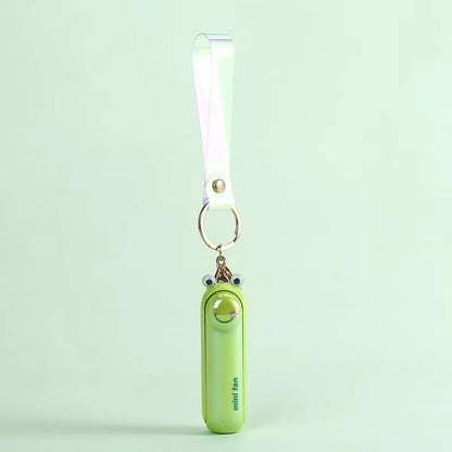 Green mini handheld keychain fan with ribbon strap and metal key ring, front view.