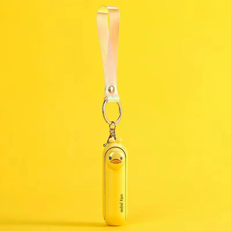 Yellow mini handheld keychain fan with ribbon strap and metal key ring, hanging view.