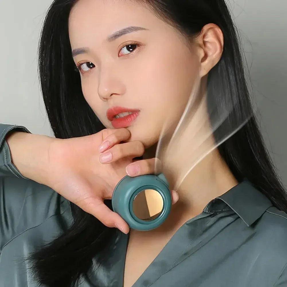 Blue bladeless waist fan held up near the mouth and blowing cool air