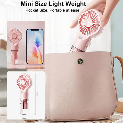 Pink pocket-size handheld mist fan with mist nozzle and transparent tank