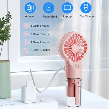 Pink USB rechargeable mist fan on a desk with visible water tank